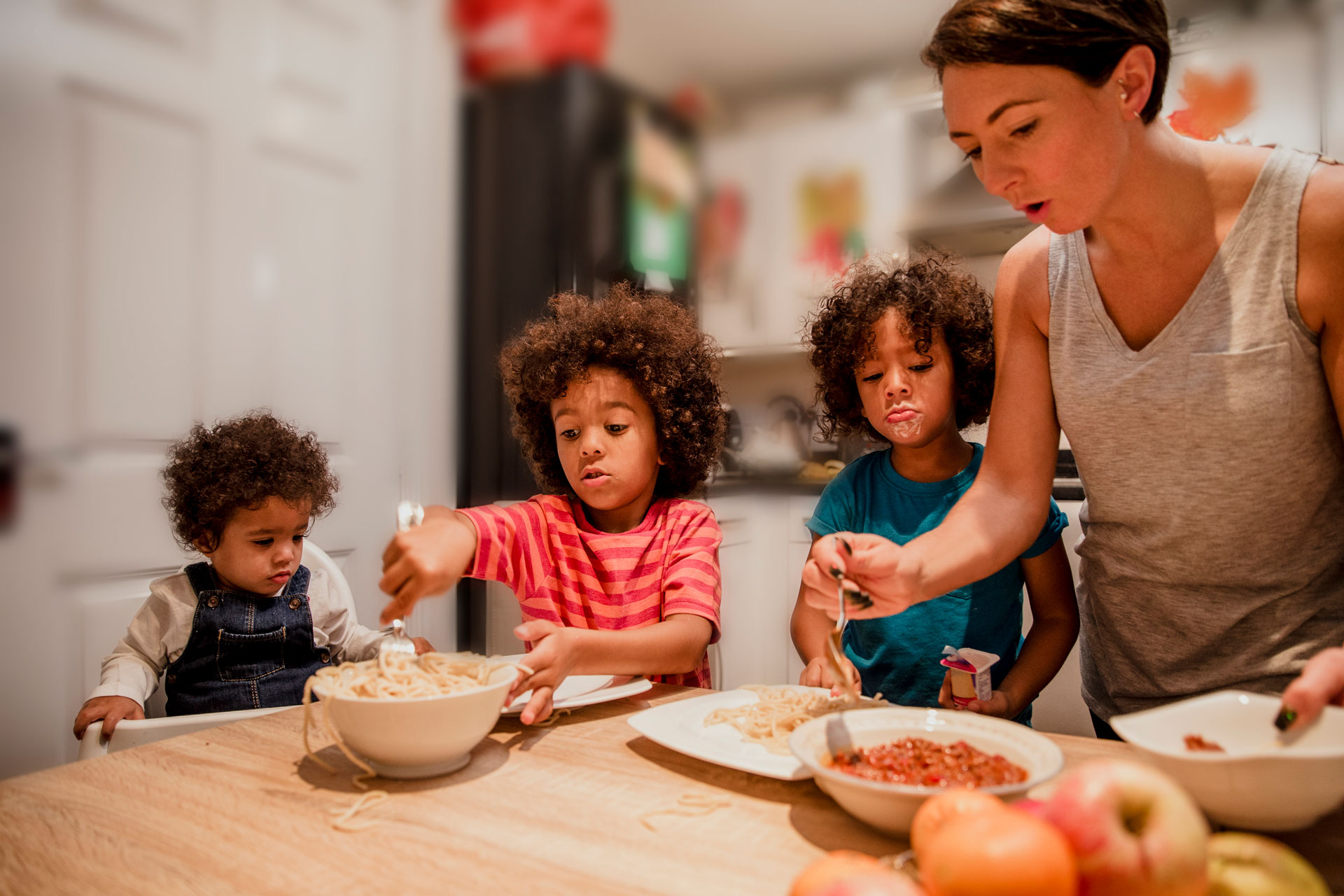 Three children eating from their plates