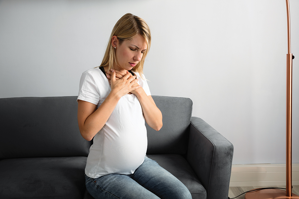 Woman in pregnancy suffering from acid reflux