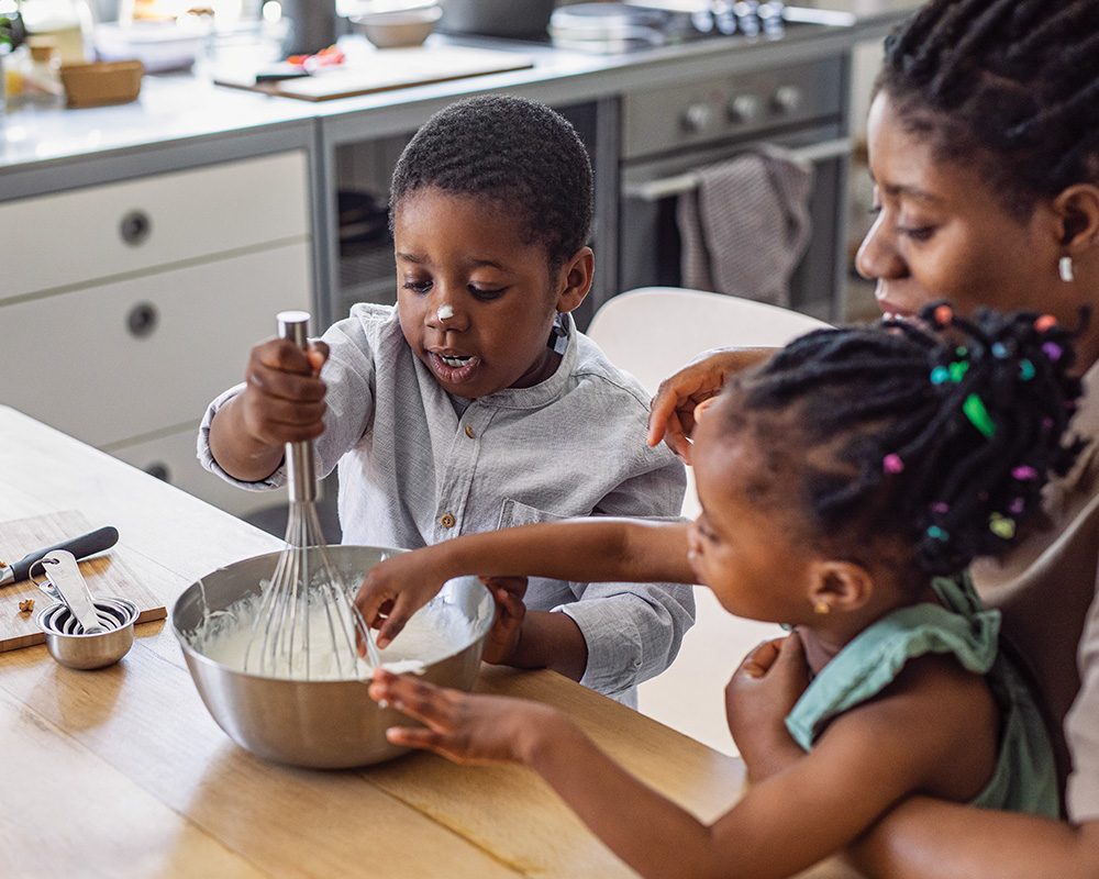 Mother and babies cooking together in the kitchen